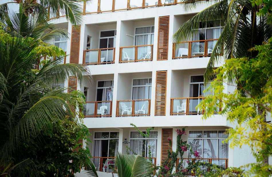 Student accommodation building with balconies and palm trees